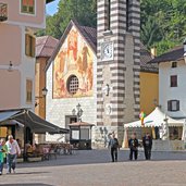 Fiera di Primiero torre civica e chiesa madonna aiuto