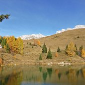 lago di pozze presso passo san pellegrino albergo miralago autunno